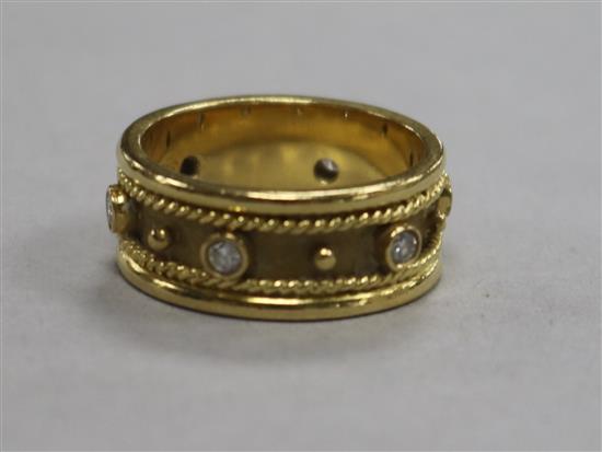 A modern 18ct gold and diamond fancy band, set with six round cut stones, size M.